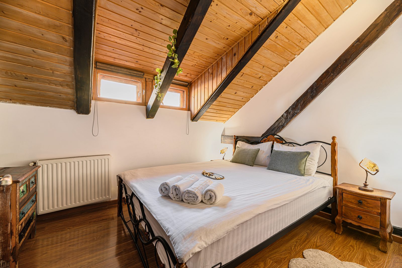Spacious attic bedroom with exposed wooden beams