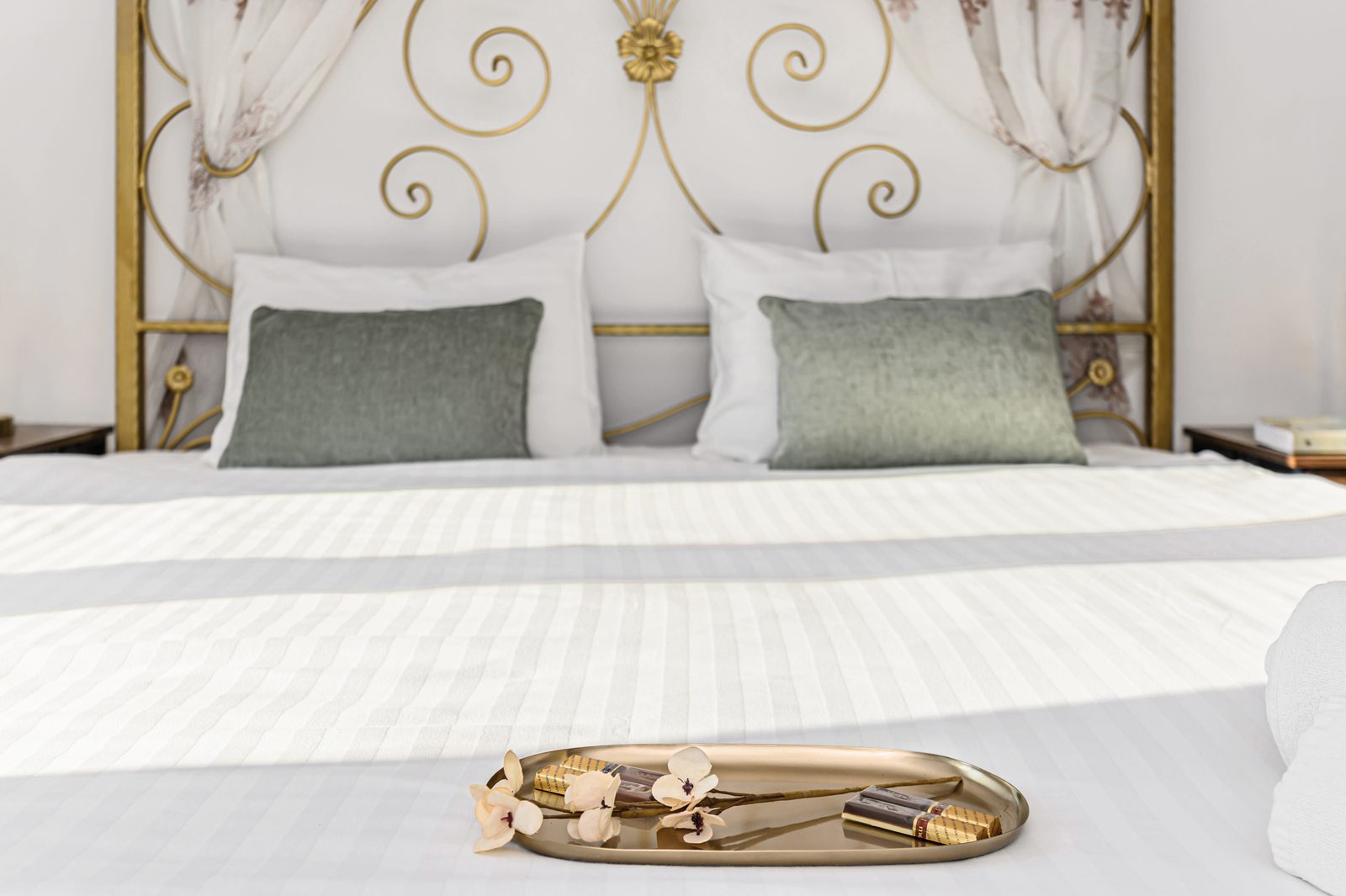 Gold bed frame detail with welcome tray